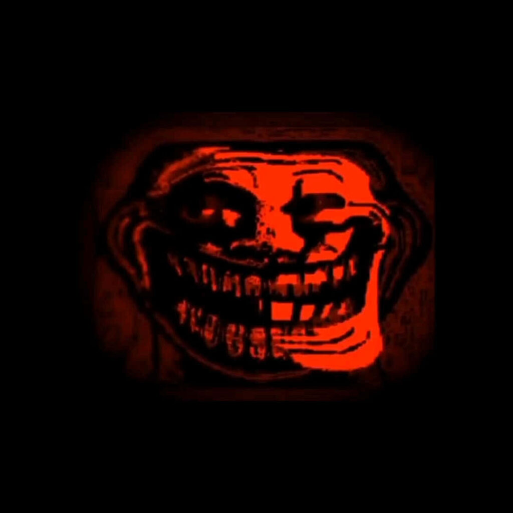 Red and Black Troll Face Meme amidst a Chilling Photographic Backdrop Wallpaper