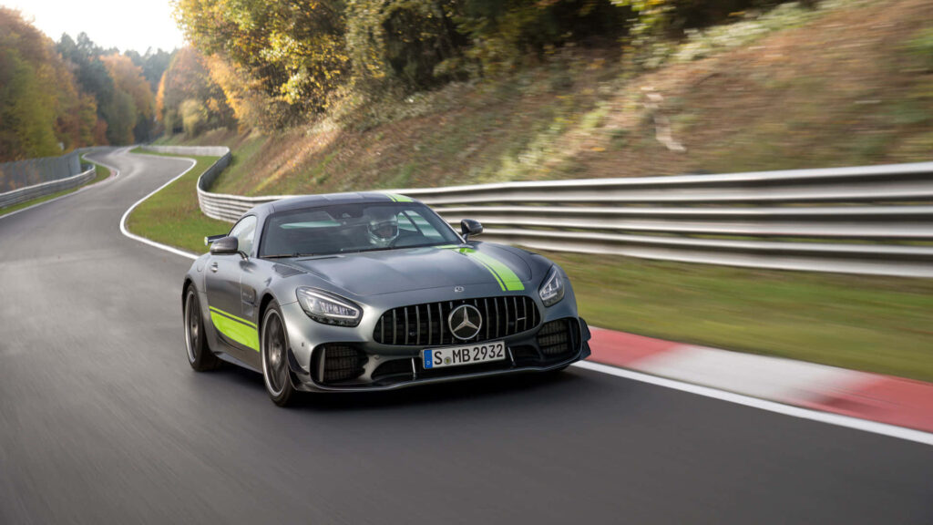 Mercedes AMG GT R 2020 Pro in motion green accents on scenic racetrack high performance car wallpaper