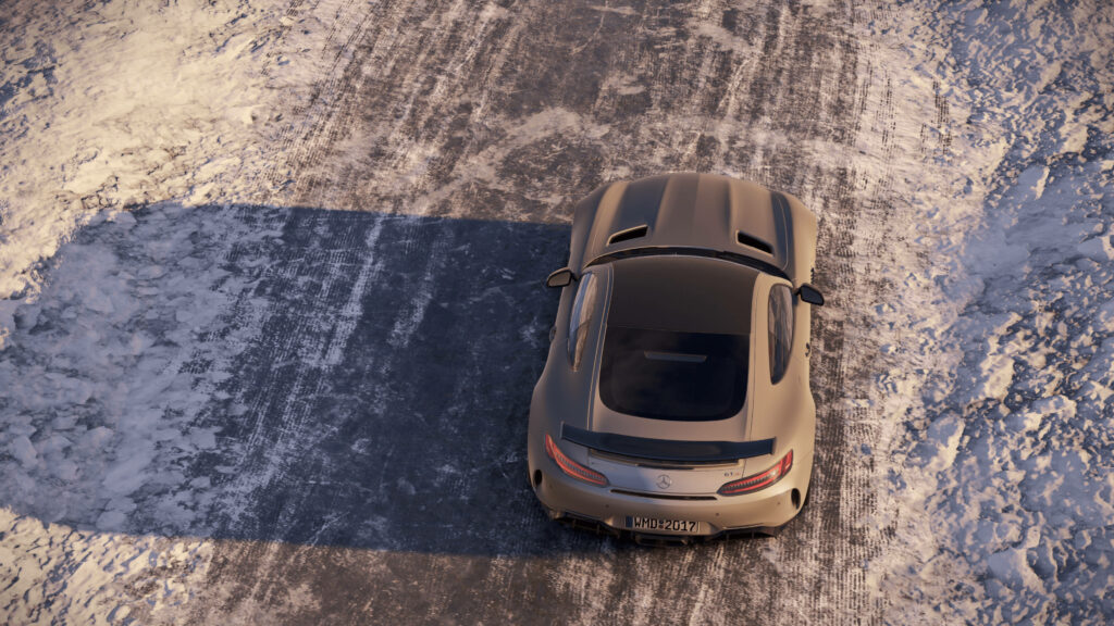 Mercedes AMG GT R driving on snowy road top view showcasing dynamic design and winter performance Wallpaper
