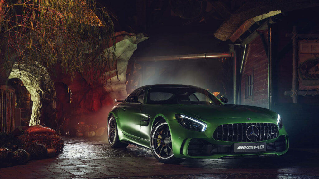 Mercedes AMG GT R vibrant green sports car with dynamic lines in nighttime wallpaper background