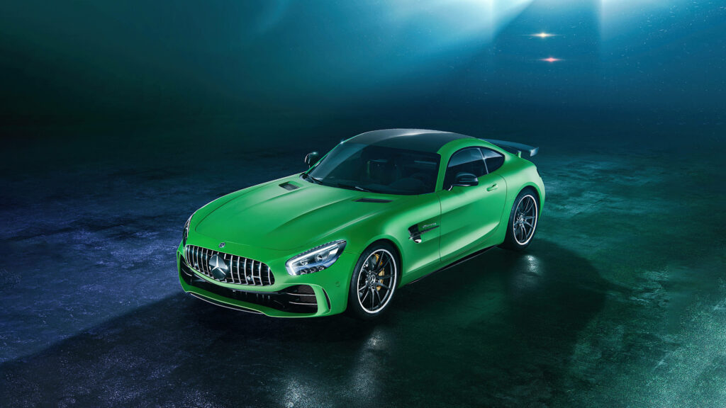 Vibrant green Mercedes AMG GT R under dramatic lighting on glossy surface sleek aerodynamic design Wallpaper