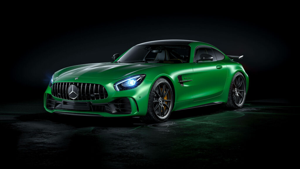 Green Mercedes AMG GT R sports car under dramatic lighting with sleek athletic curves wallpaper