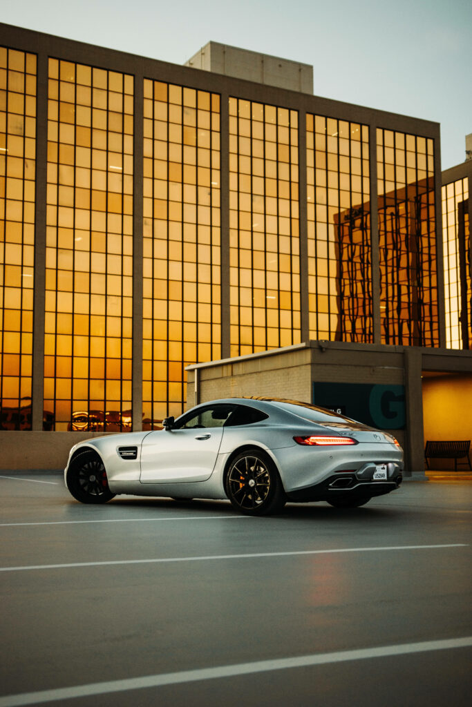 Mercedes-AMG GT R parked in modern cityscape with golden sunset reflections luxury sports car wallpaper