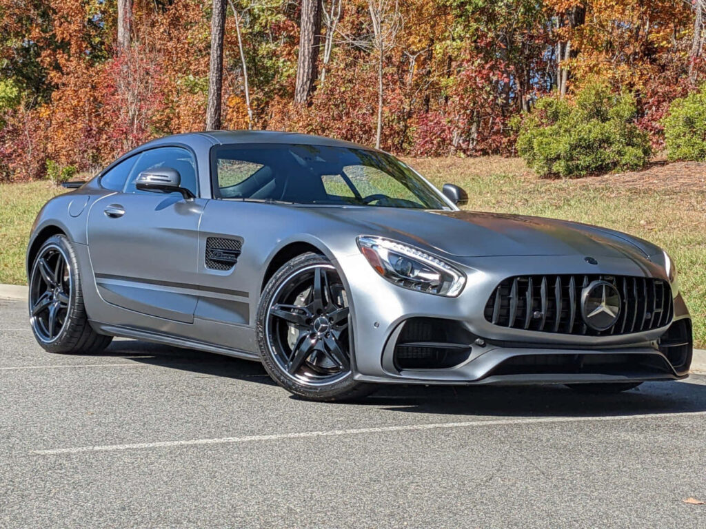 Mercedes AMG GT-R matte gray sports car parked on autumn day with colorful trees background Wallpaper