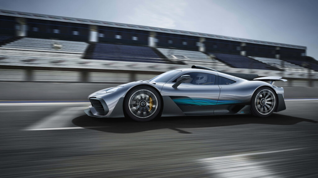 Mercedes AMG racing fast on track with blurred grandstand background high speed performance Wallpaper