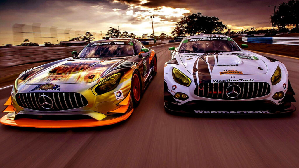 Two Mercedes AMG sports cars racing side by side on track at sunset showcasing speed and design Wallpaper