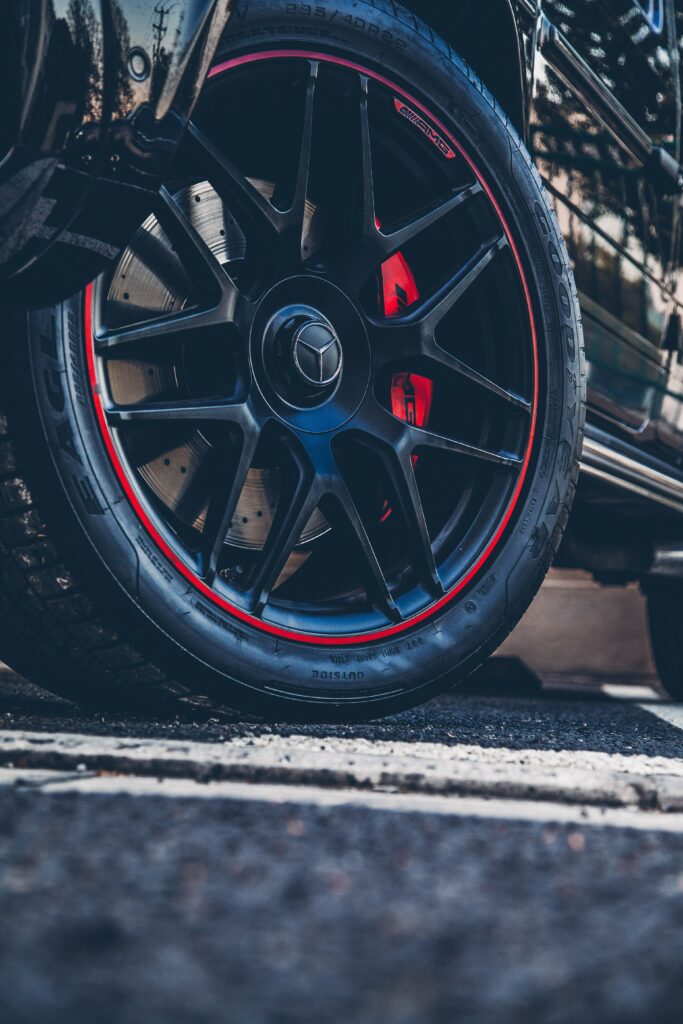 Close-Up of Mercedes Wheel: Sleek Black Rims with Red Accents Wallpaper