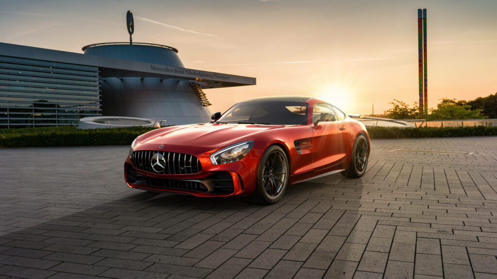 Red Mercedes AMG GT R parked at sunset by iconic Mercedes building luxury sports car wallpaper