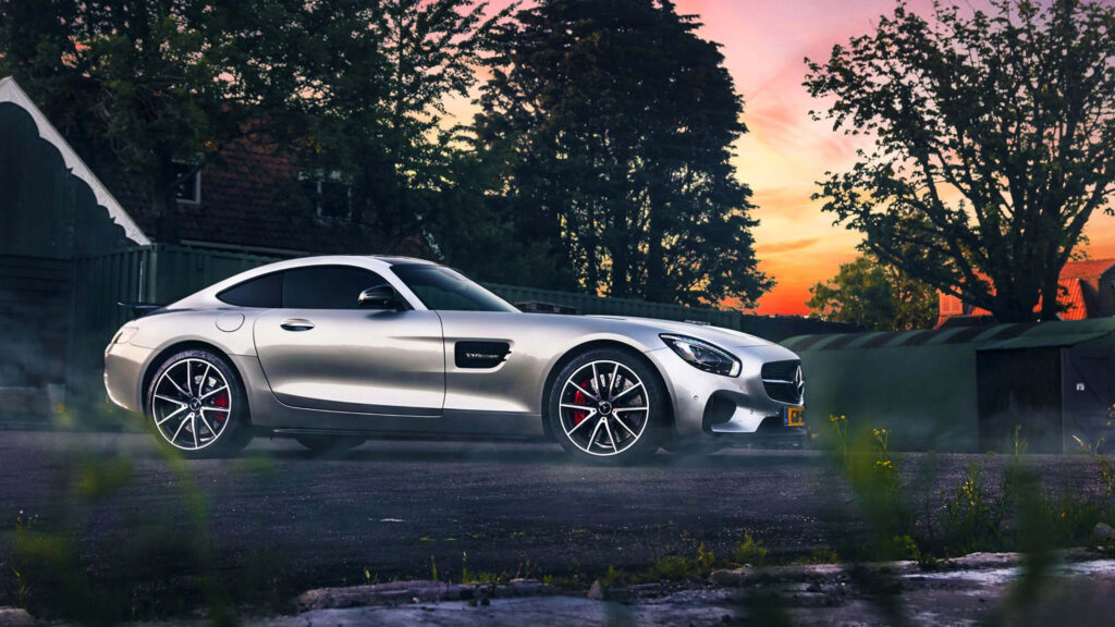 Light grey Mercedes-Benz SLS AMG parked at sunset showcasing sleek design and power outdoors Wallpaper