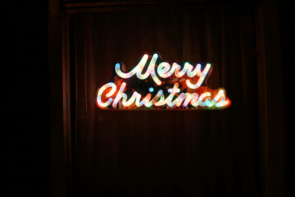 Colorful Cheer: A Merry Christmas LED Signage Lights Up the Night Wallpaper