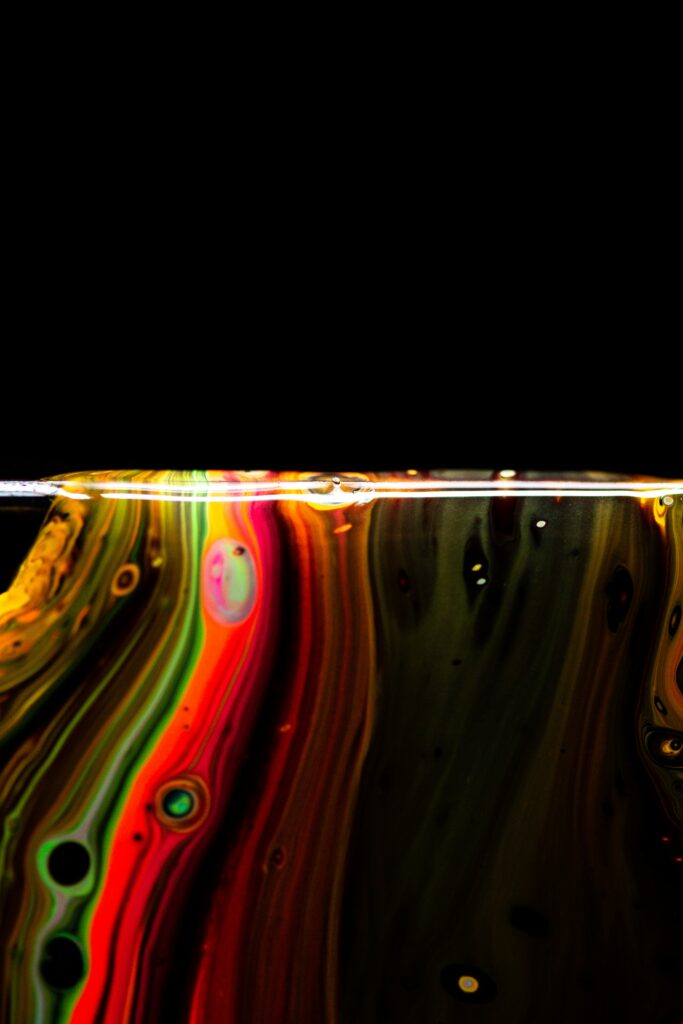 Vibrant Abstract Liquid Paint Wallpaper on Black Background