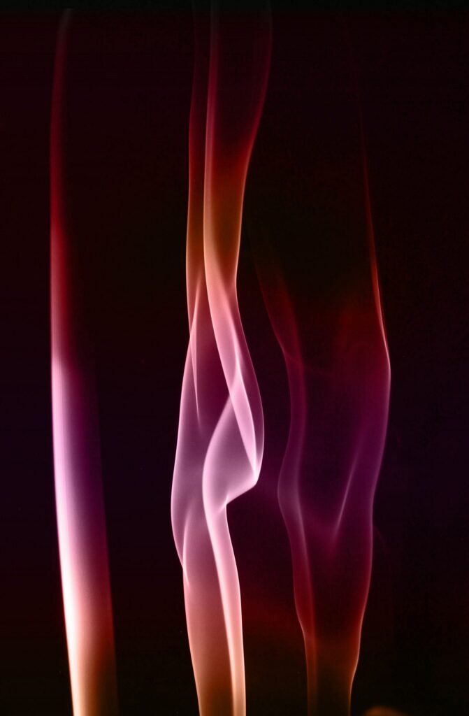 Mesmerizing Abstract Wallpaper: Colorful Smoke Trails on Dark Background