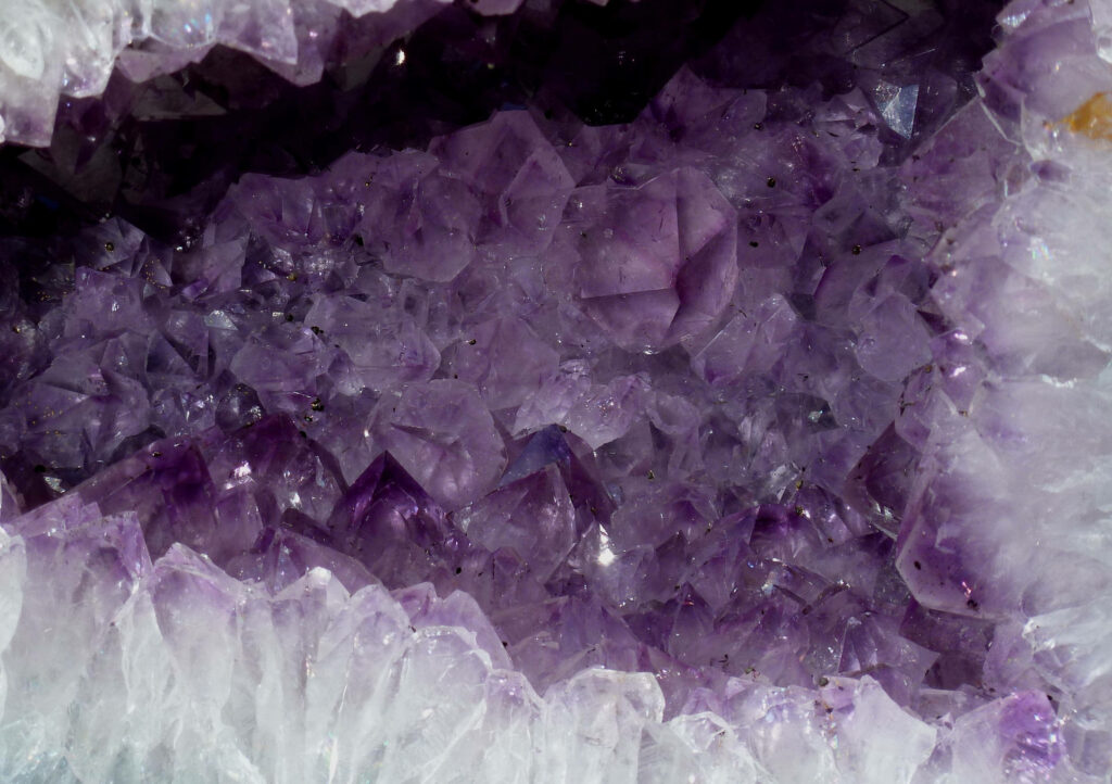 Close-up of vibrant purple amethyst geode crystals with detailed natural formations wallpaper