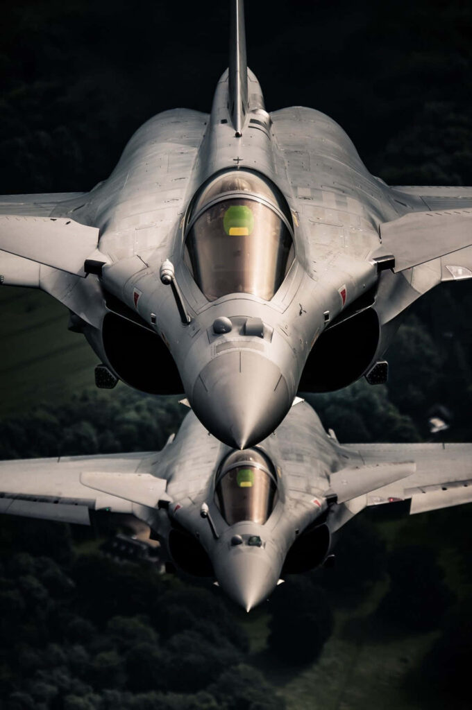 Majestic Dassault Rafale Jets Soaring Amidst Enigmatic Greenery Wallpaper