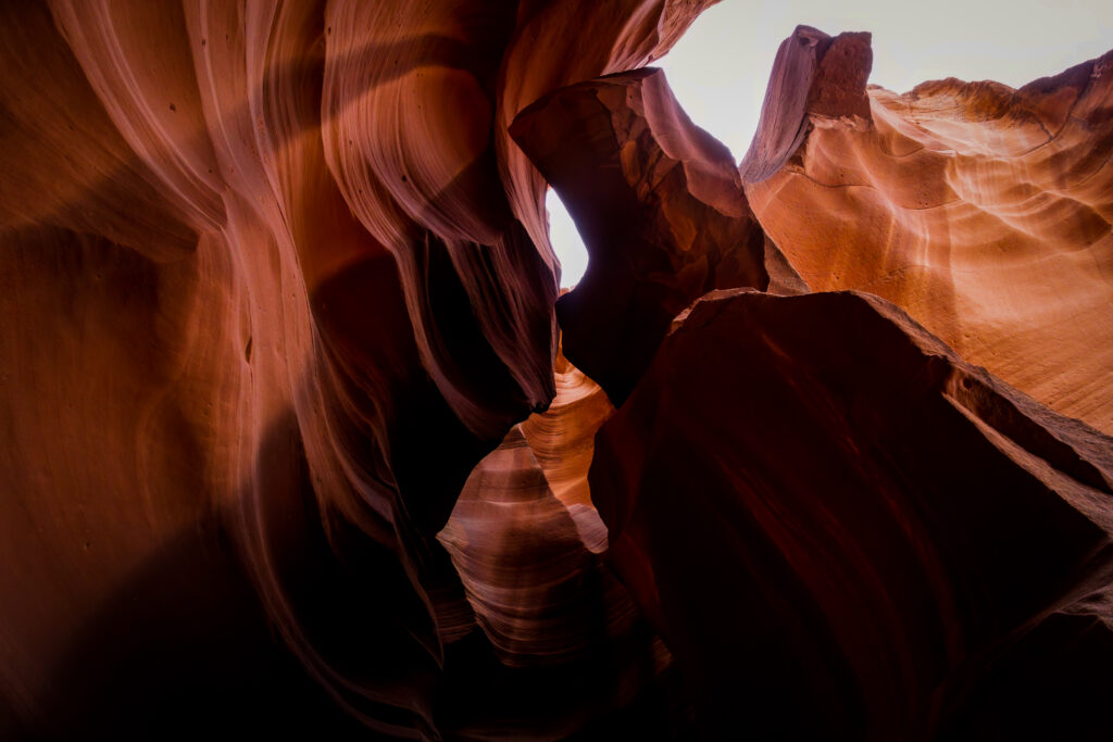 Antelope Canyon textured red and orange rock formations with dramatic light and shadow relief Wallpaper