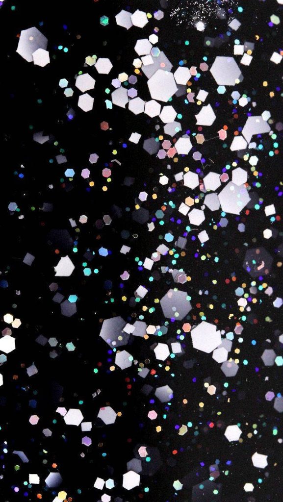 Black glitter wallpaper with hexagonal sparkles and iridescent red blue green highlights