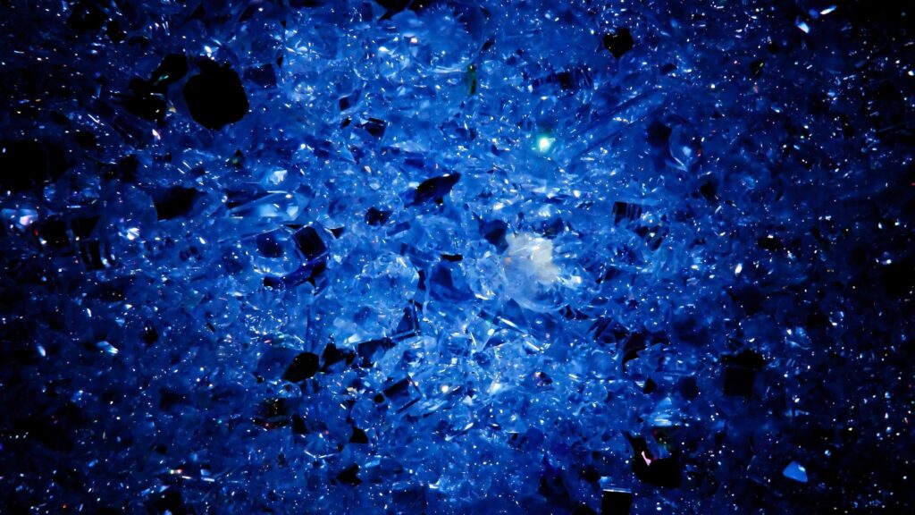Mesmerizing blue crystal cluster wallpaper shimmering with intricate facets and dazzling reflections