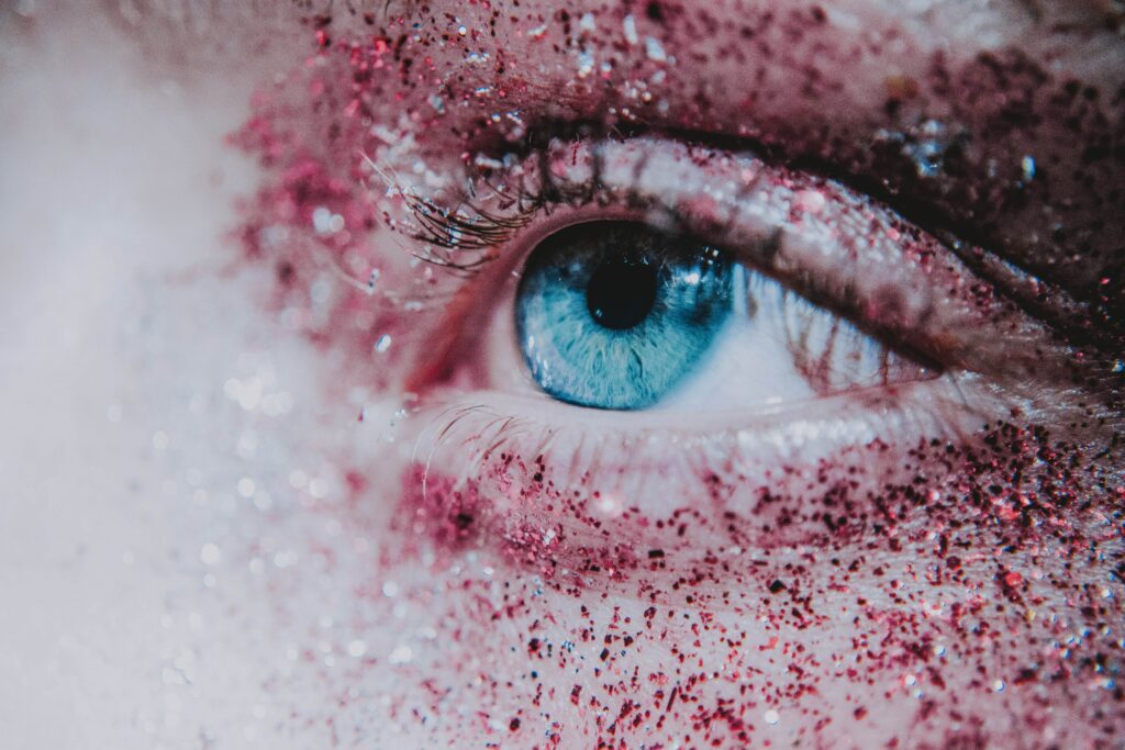 Vibrant Blue Eye Close-Up with Sequins & Glitter Wallpaper