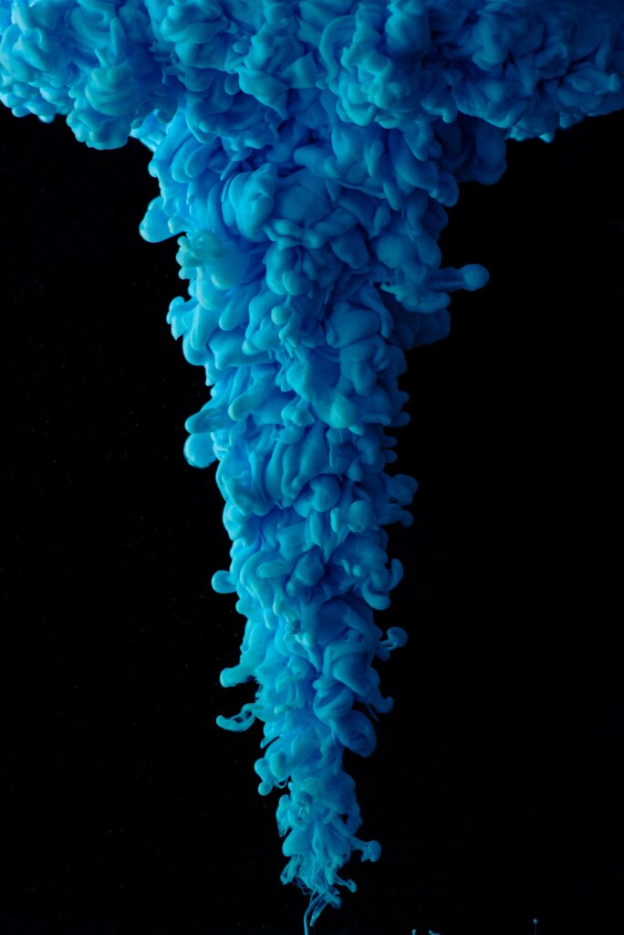 Mesmerizing Blue Ink Swirls in Water: Captivating Black Background Wallpaper