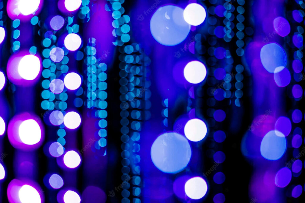 Vibrant blue and purple glowing LED circles creating a dreamy futuristic bokeh wallpaper background