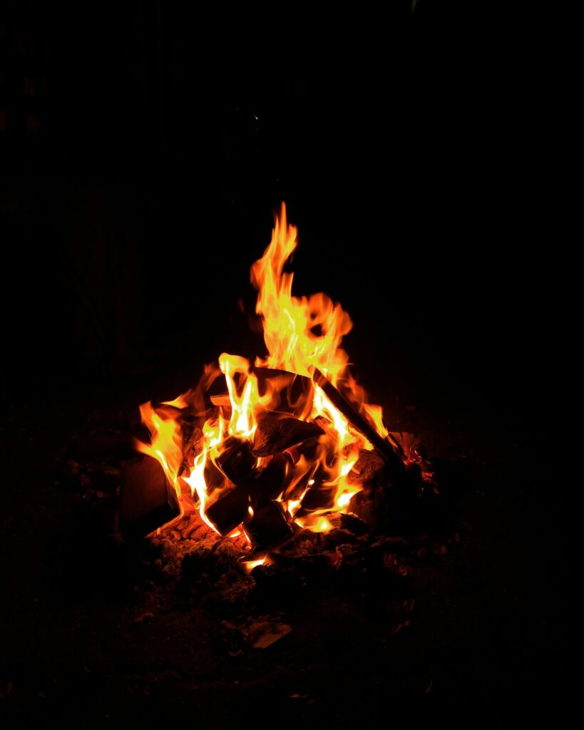 Mesmerizing Bonfire Wallpaper: Vivid Flames on Black Background