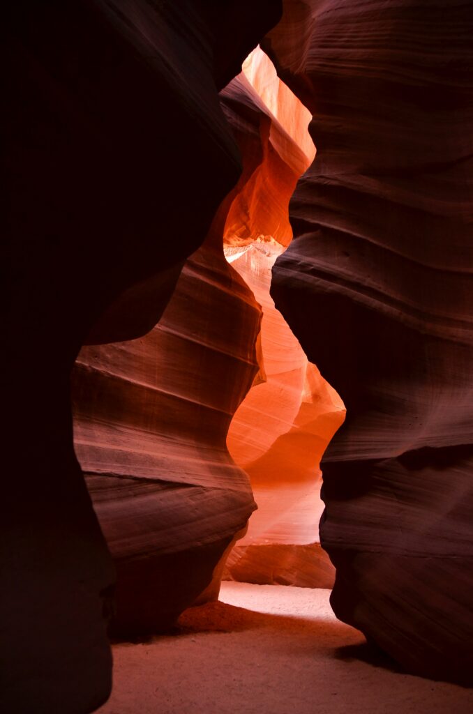 Mesmerizing cave interior with warm light highlighting natural rock formations and textures Wallpaper