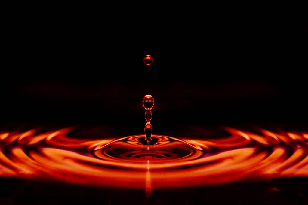 Stunning Red Liquid Drop Ripples - Dark Background Wallpaper