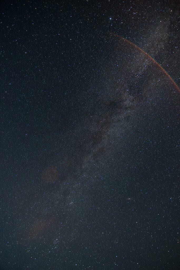 Vibrant cosmic wallpaper with swirling nebula glowing galaxies and stars in deep dark space