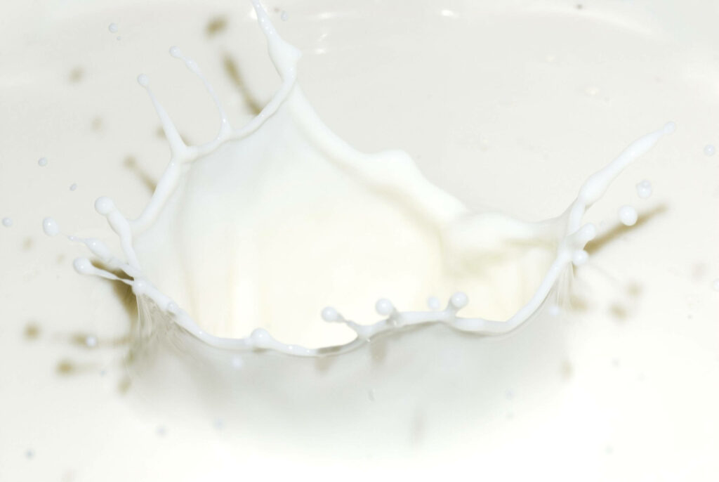 Artistic Dairy Milk Splash Wallpaper Background - Close-Up Design