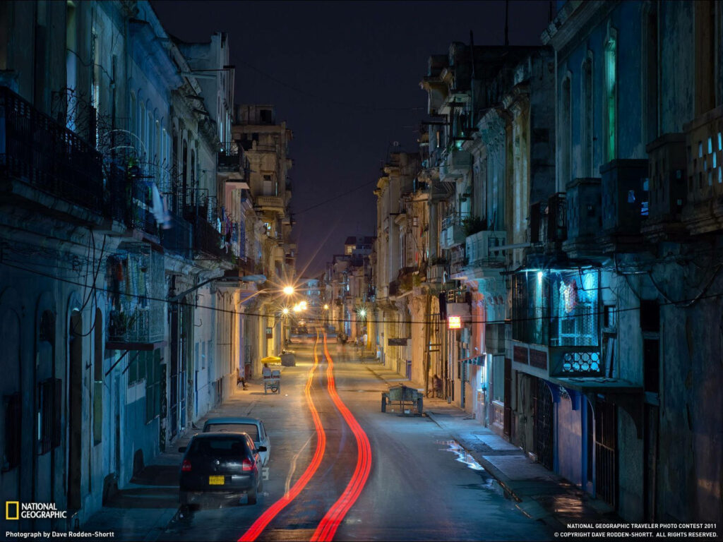 Charming Cuban Street at Night: Vibrant Colonial Architecture Wallpaper