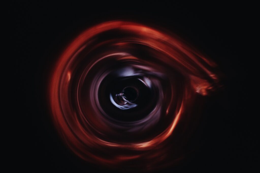 Abstract Dark Vortex Wallpaper: Swirling Red & Black Depth Background