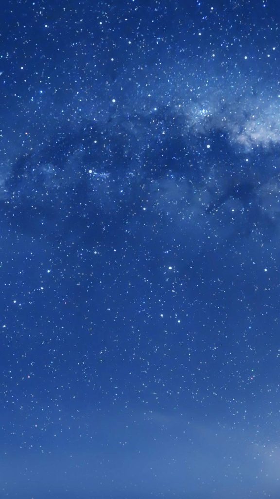 Deep blue night sky iOS wallpaper with twinkling stars and faint Milky Way cosmic backdrop