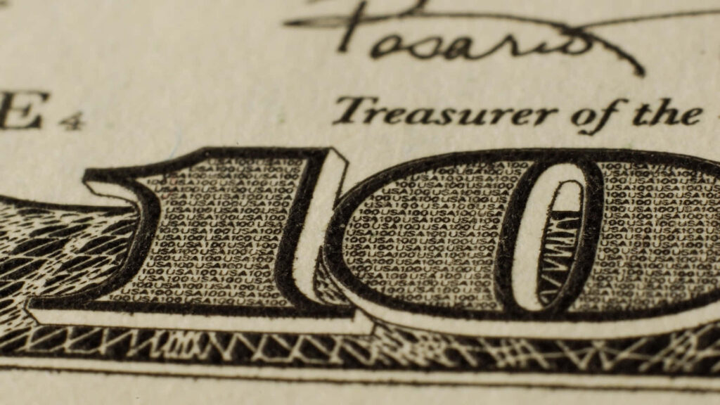 Captivating Macro Shot Revealing the Intricate Details of a 100-Dollar Bill's Number Wallpaper