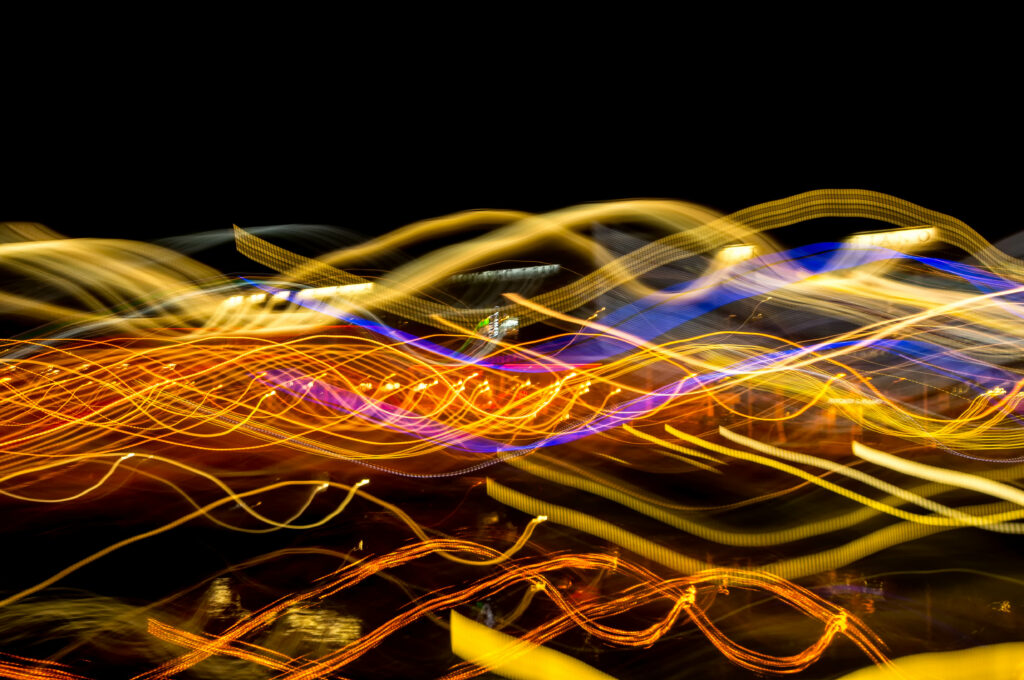 Dynamic Long Exposure: Glowing Threads Create Abstract Motion Effects Wallpaper