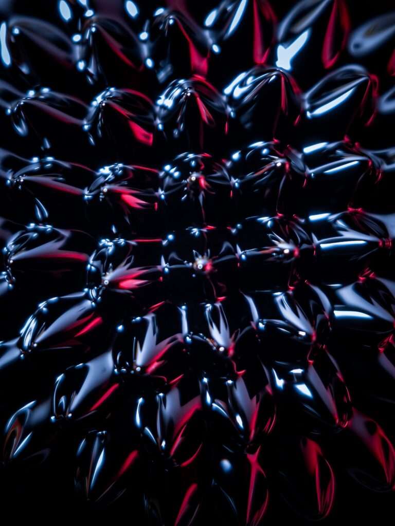 Mesmerizing Ferrofluid Wallpaper: Close-Up with Red & Blue Hints