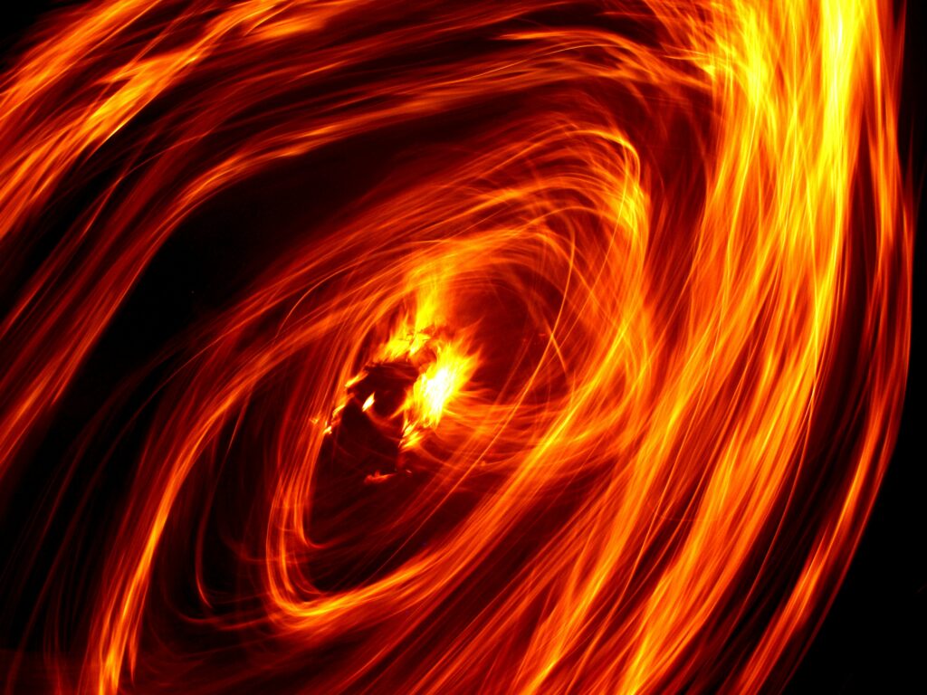 Mesmerizing Freezelight Wallpaper with Vibrant Orange & Yellow Spirals