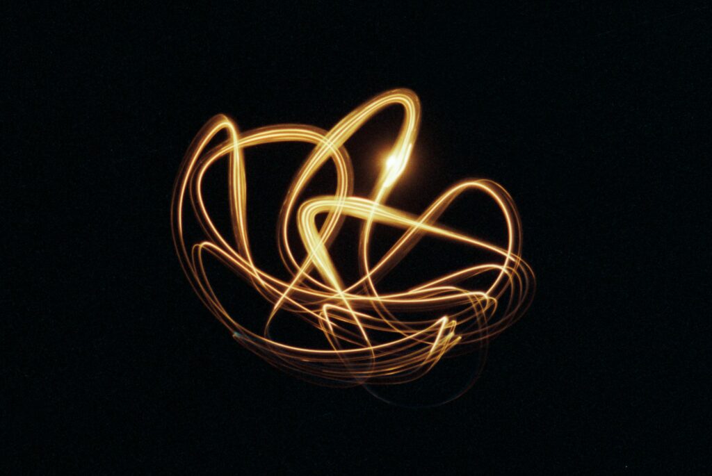 Mesmerizing Freezelight Photography Wallpaper: Glowing Patterns on Black