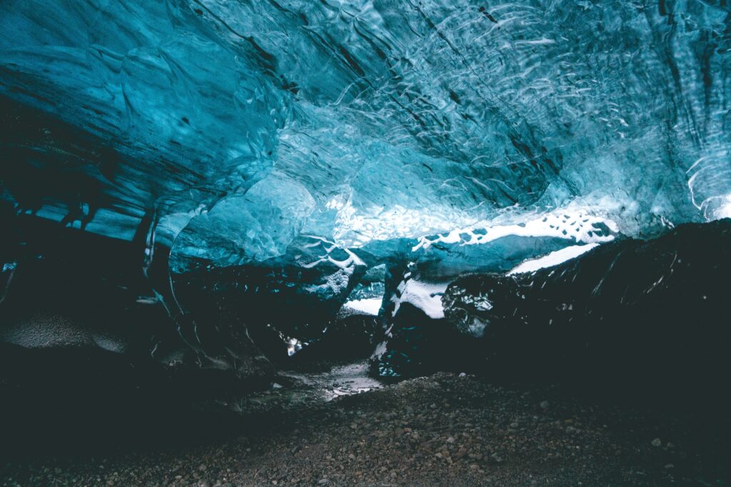 Mesmerizing icy cave in Iceland with glimmering blue ice formations and frosty textures wallpaper