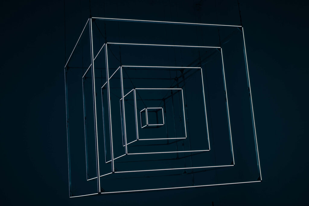 Mesmerizing Light Sculpture: Geometric Illusions on Dark Wallpaper