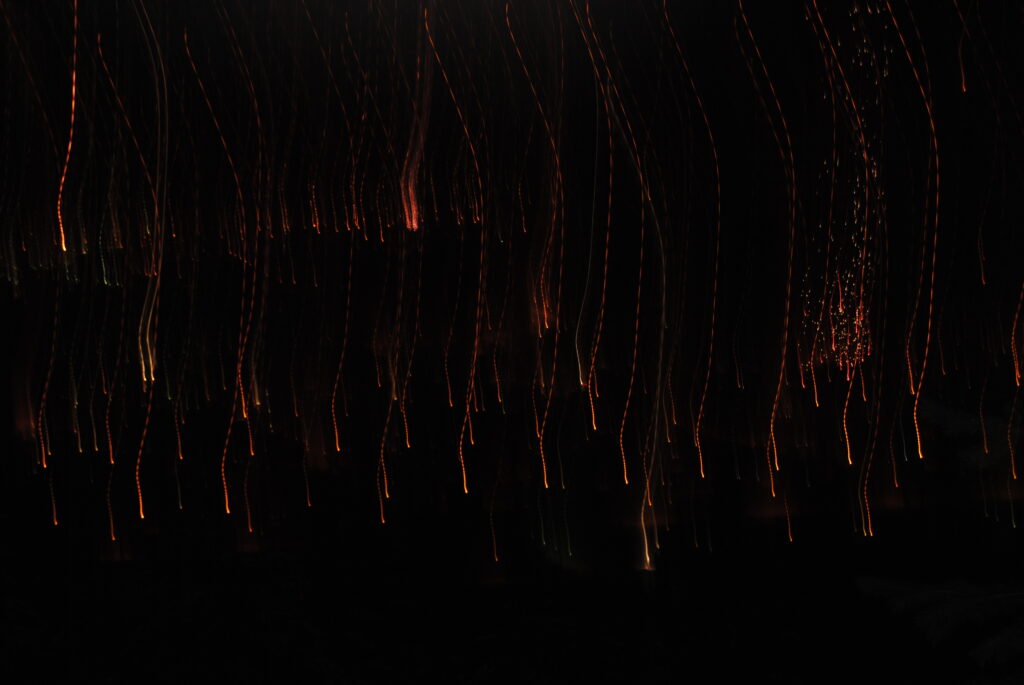 Mesmerizing Light Trails Wallpaper: Surreal Illuminated Rainfall Effect