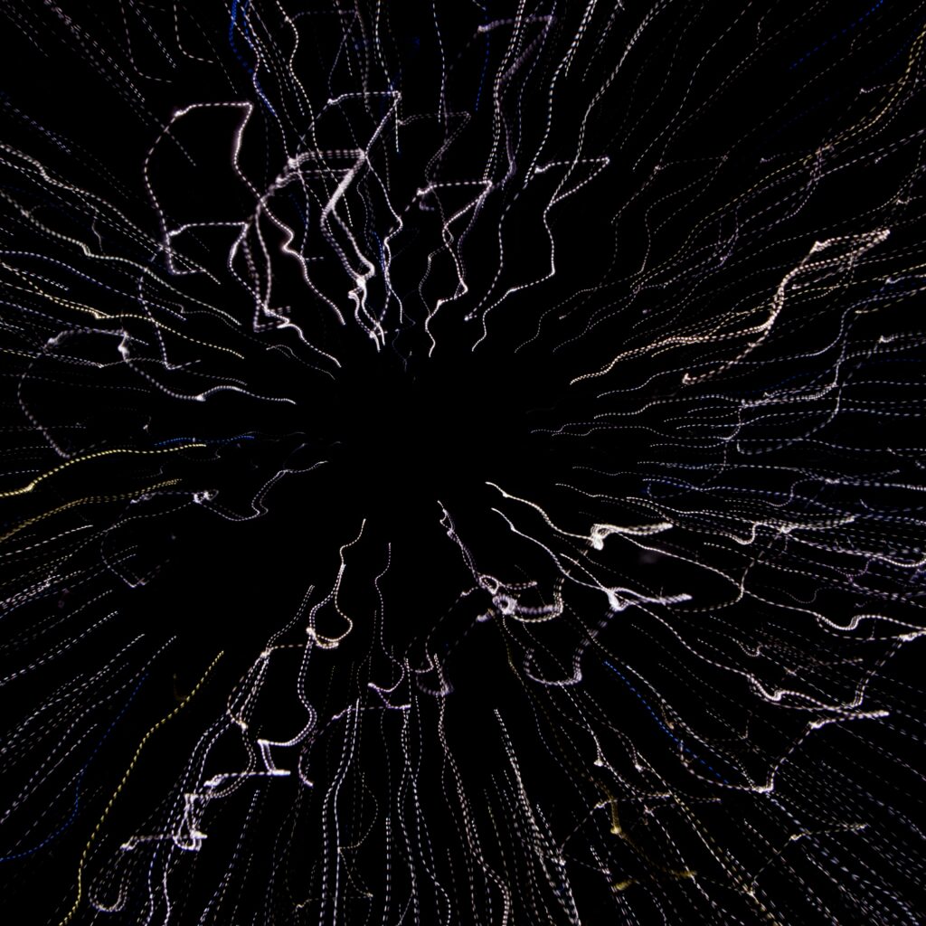 Dynamic Light Trails Wallpaper: Mesmerizing Energy on Dark Background