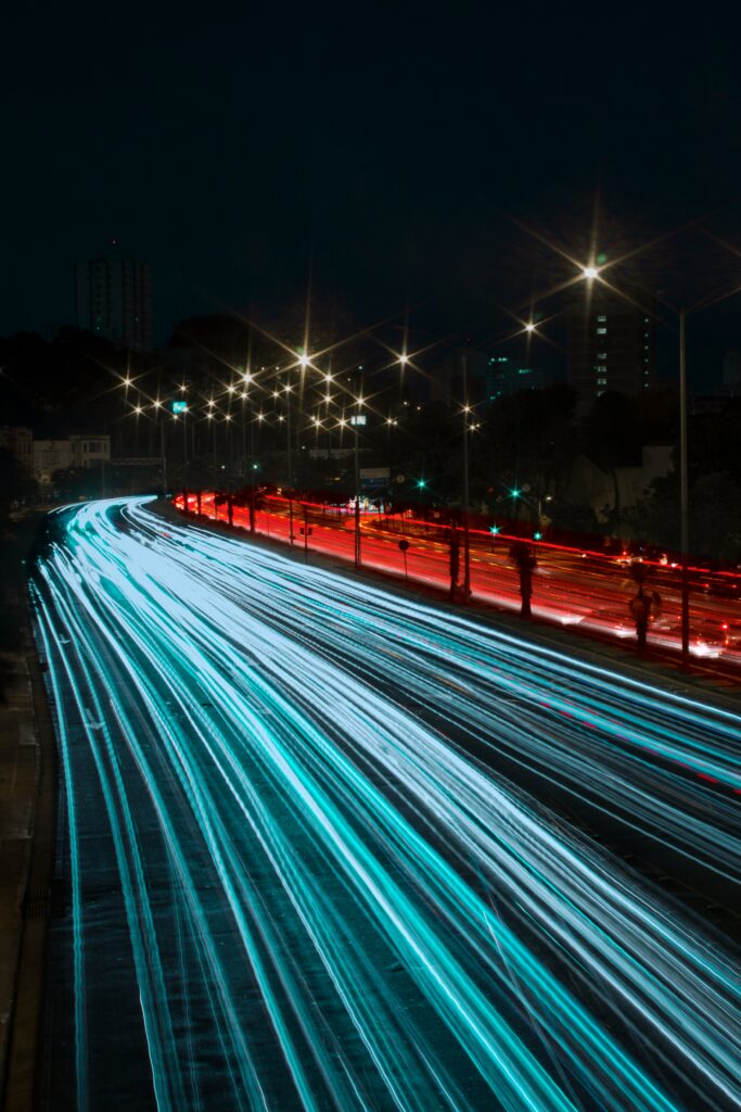 Vibrant Night Long-Exposure Wallpaper: Curved Road & Light Trails