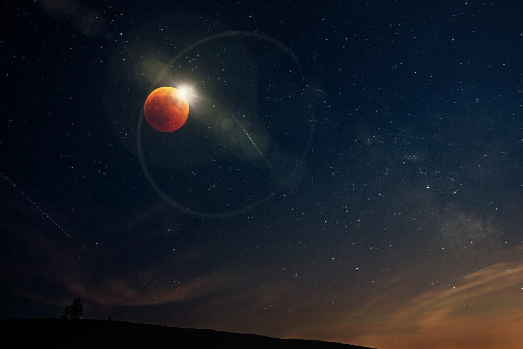 Stunning Lunar Eclipse Wallpaper: Glowing Red Moon & Starry Sky