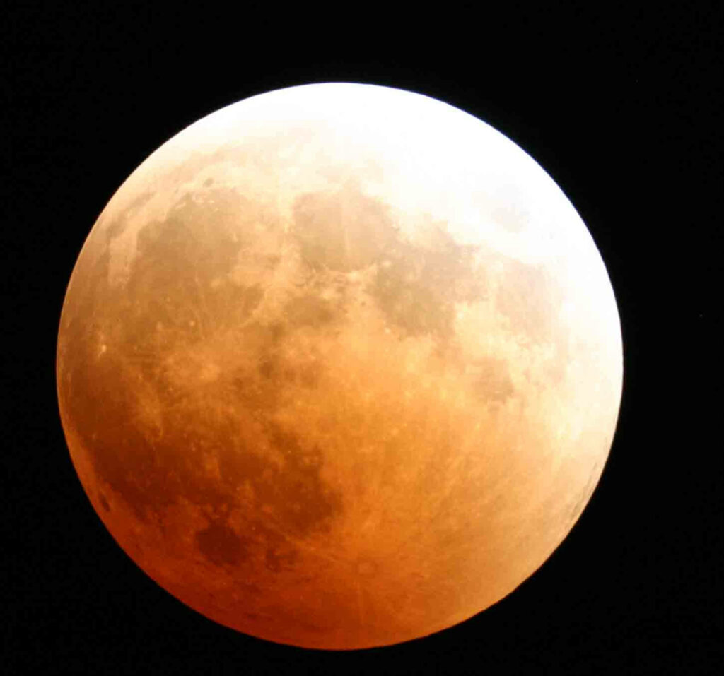 Stunning Lunar Eclipse Wallpaper: Moon in Warm Orange-Red Glow