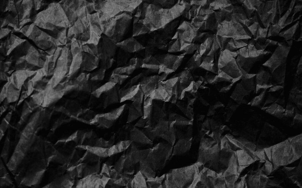 Vintage Elegance: Macro Shot of Crumpled Black Paper Unveiling Old-world Charm Wallpaper