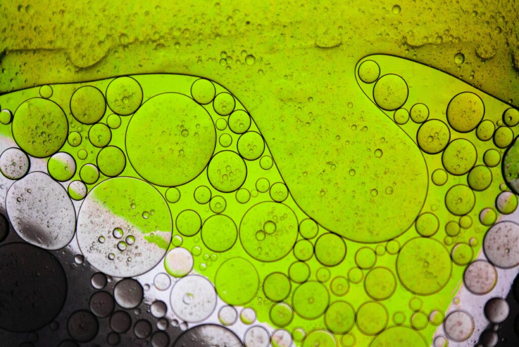 Vibrant Green Oil Bubbles: Mesmerizing Macro Wallpaper Background