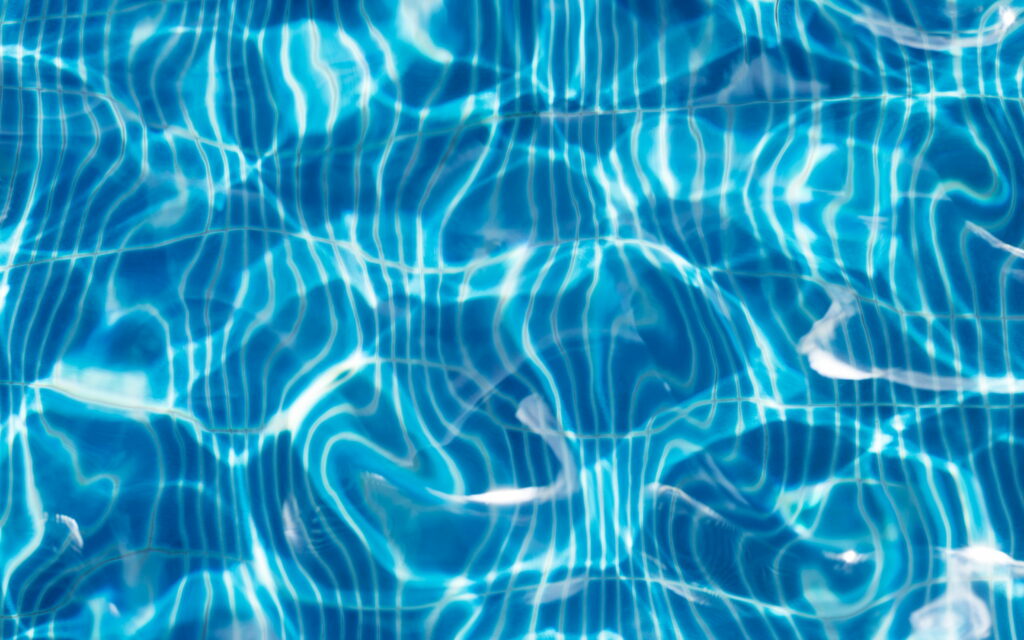 Mesmerizing Macro Waves: A Captivating Blue Water Texture Close-Up Wallpaper