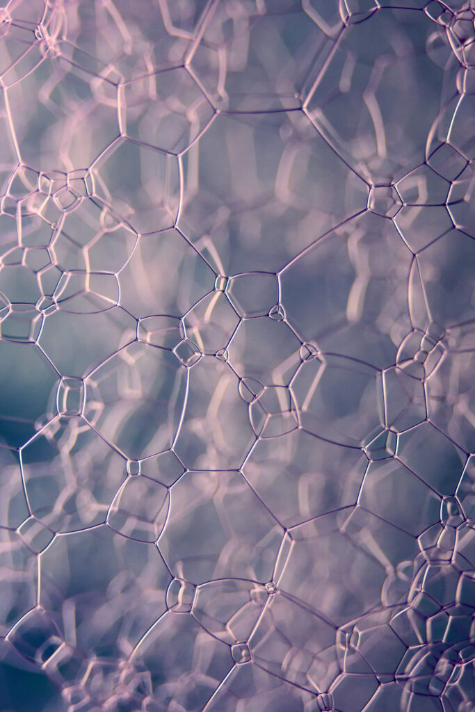 Mesmerizing Macro Soap Bubbles: Intricate Mesh in Soft Pink & Purple Wallpaper