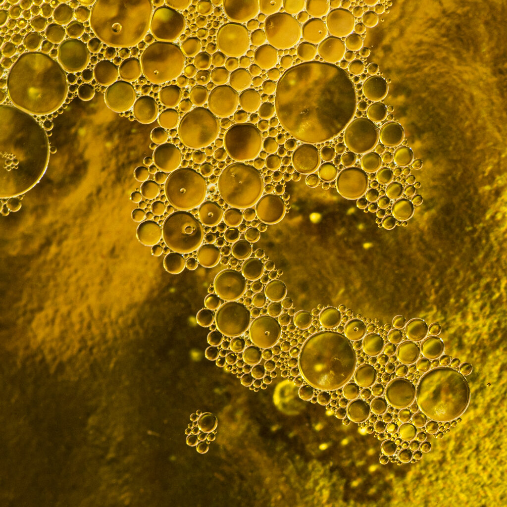 Mesmerizing Macro Bubble Wallpaper in Yellow Liquid Background