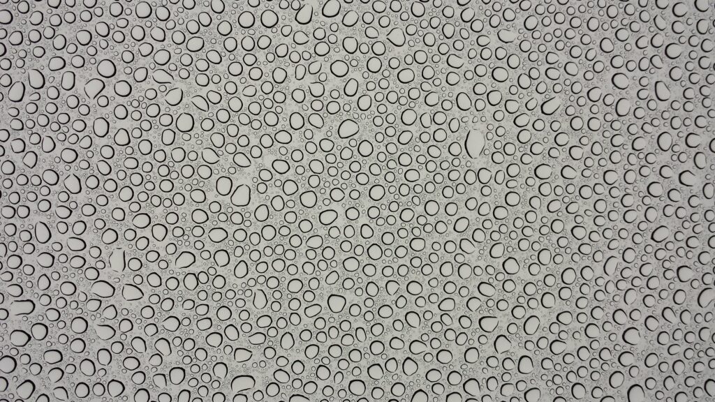 Intricate Water Droplets Macro Wallpaper on Gray Surface